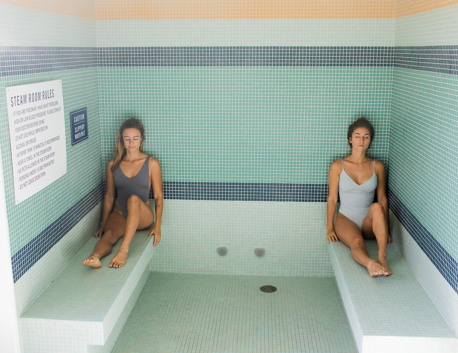 Image shows two women sitting in the steam room at MoonAcre spa