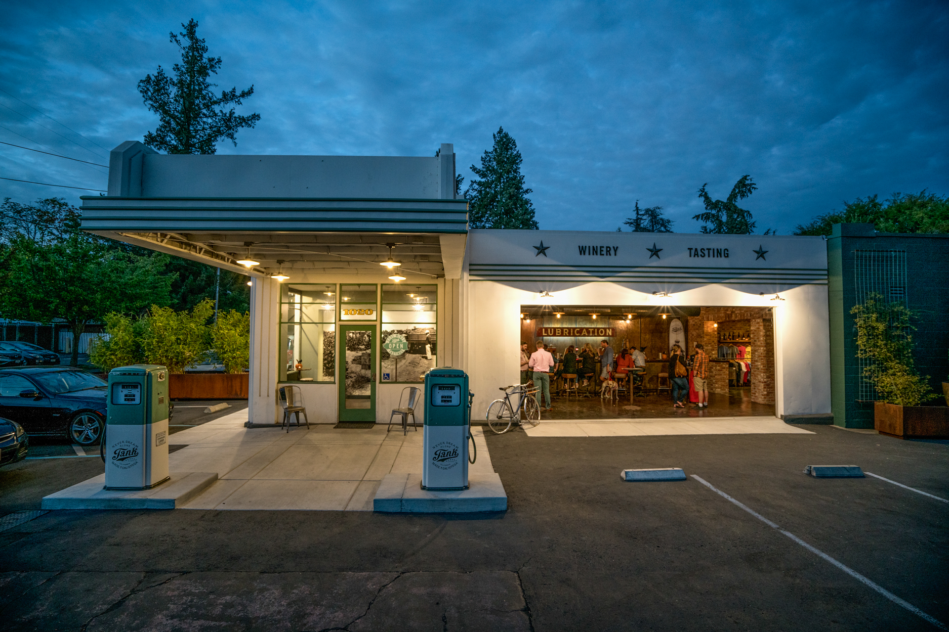 image shows the front of tank winery with lighting at night.