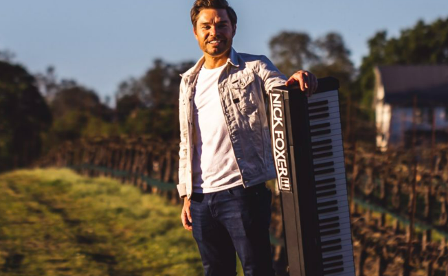 images shows Nick Foxer standing with his keyboard