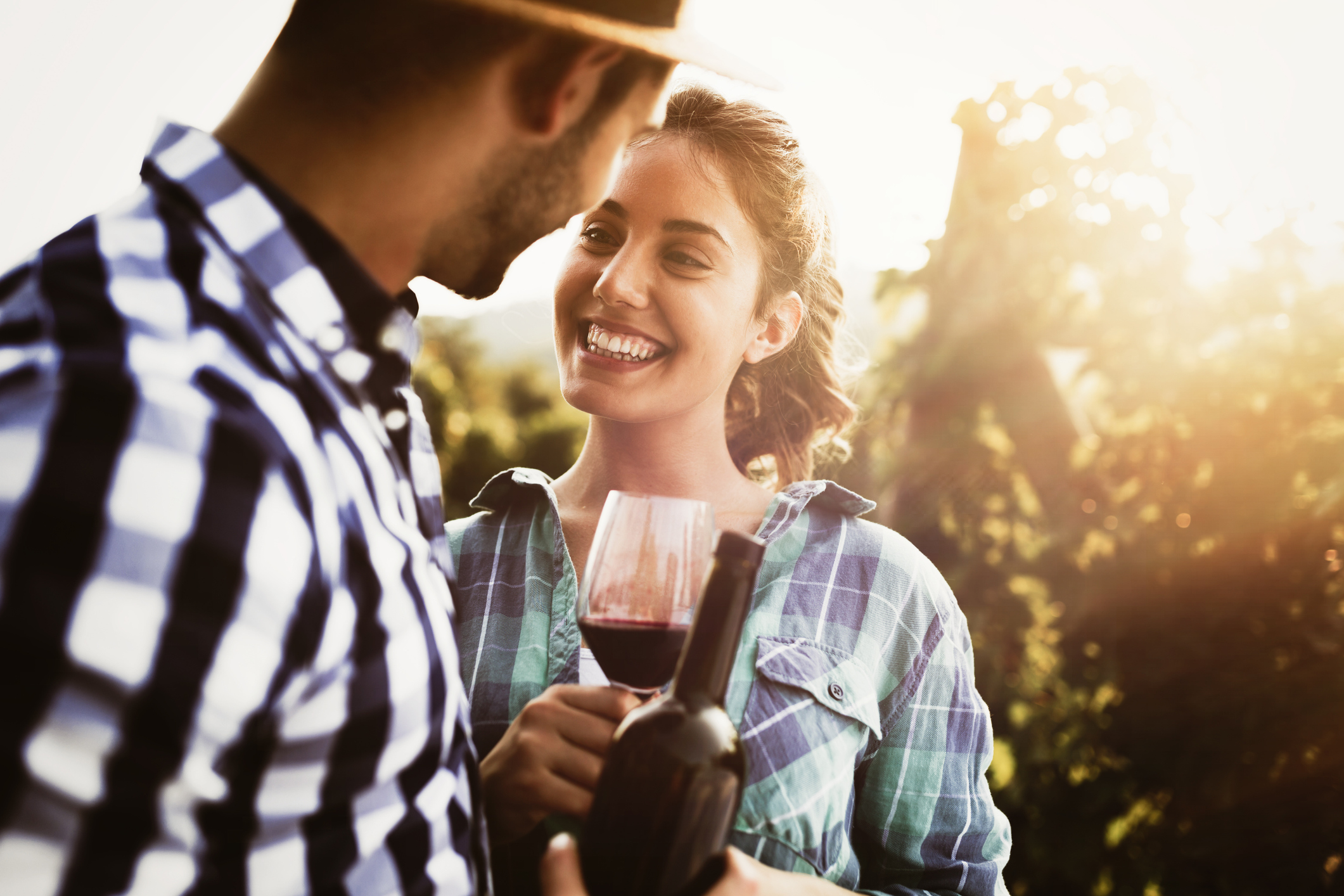 man and woman in a vineyard drinking wine