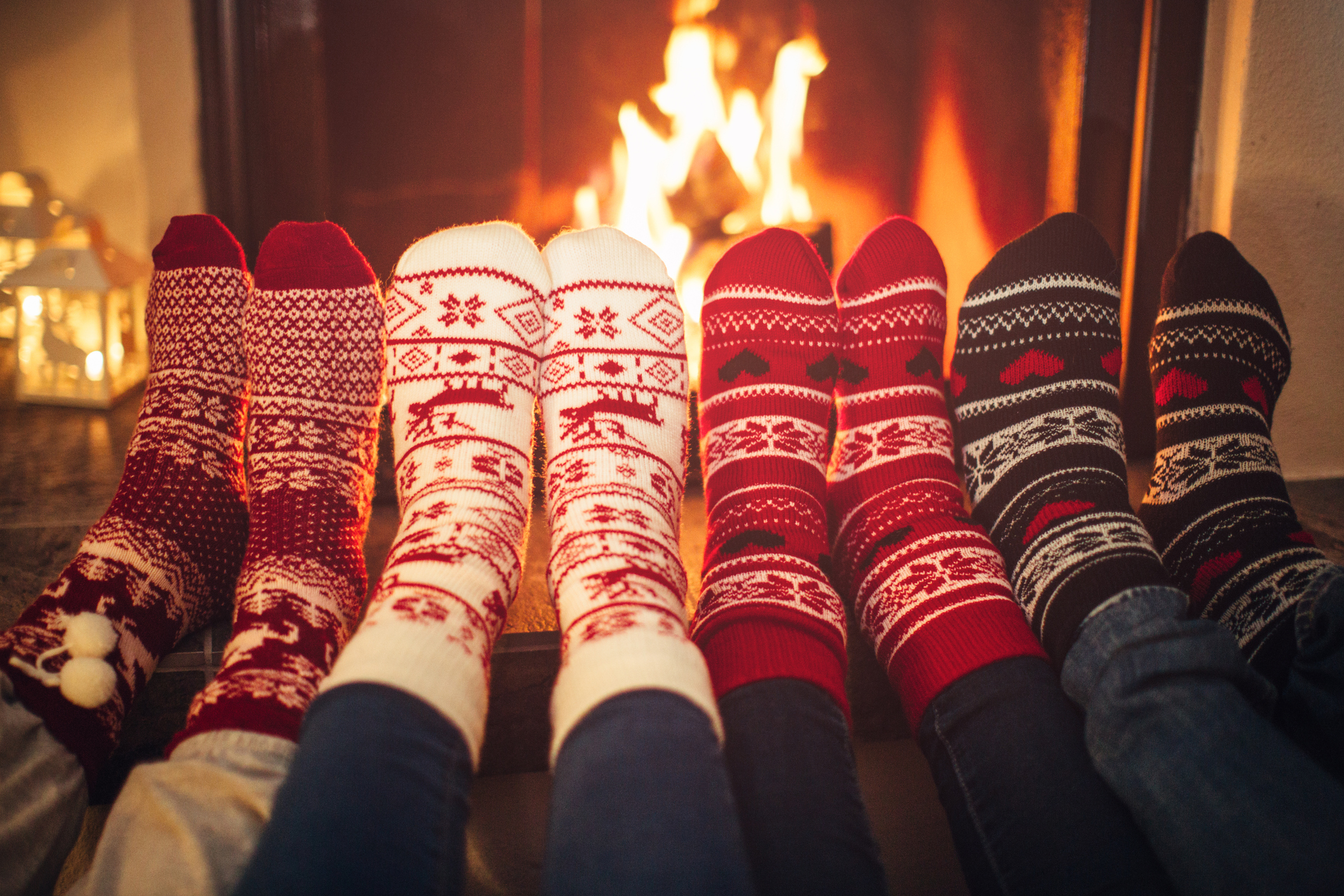 fuzzy holiday socks in front of a fire.