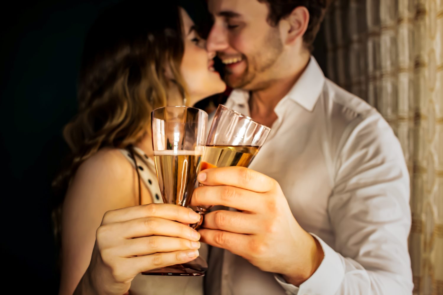 man and woman holding a glass of champagne